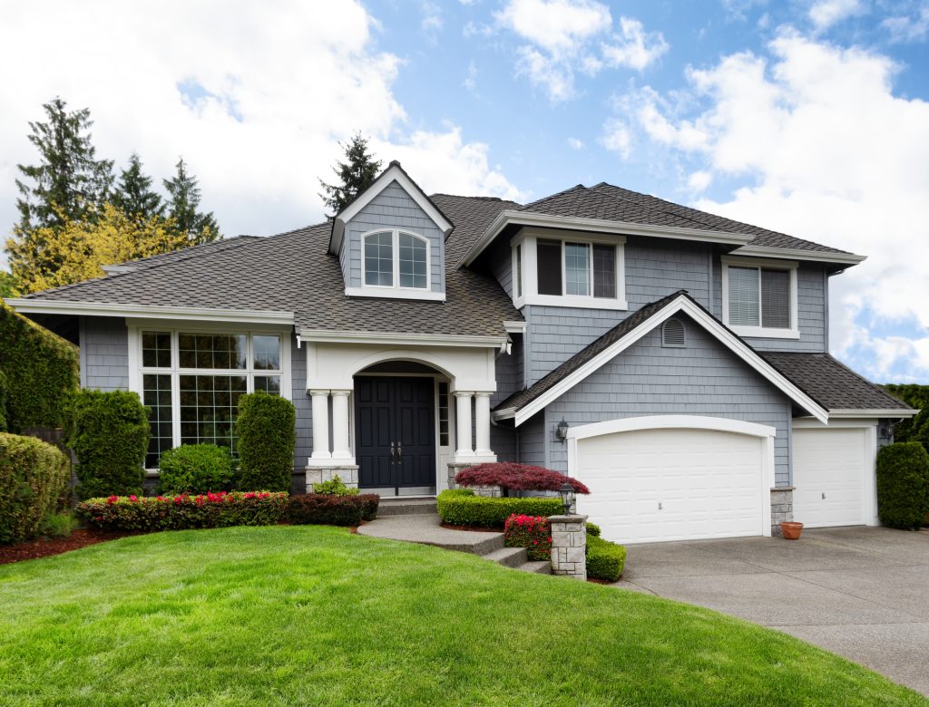 Clean home with healthy front yard during late spring season